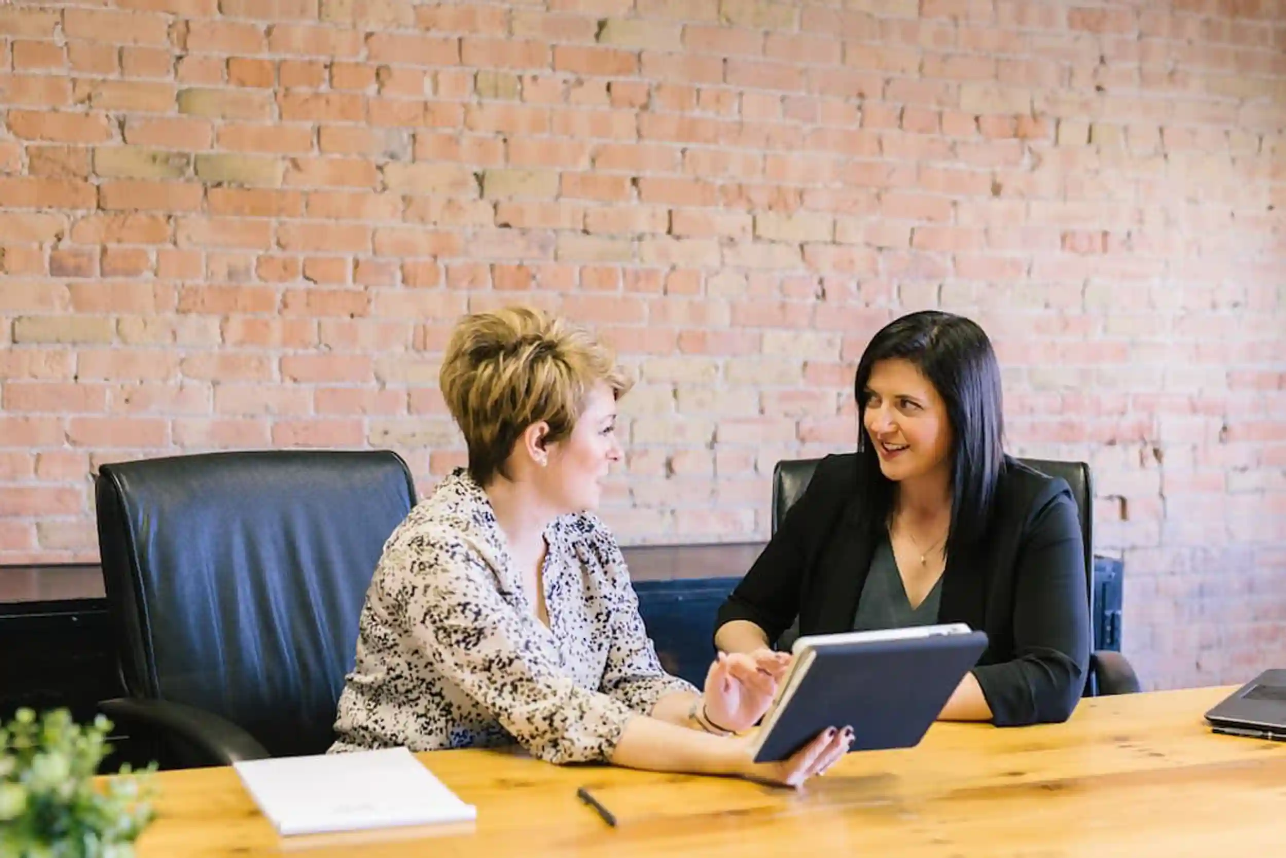 two professional women reviewing workplace performance
