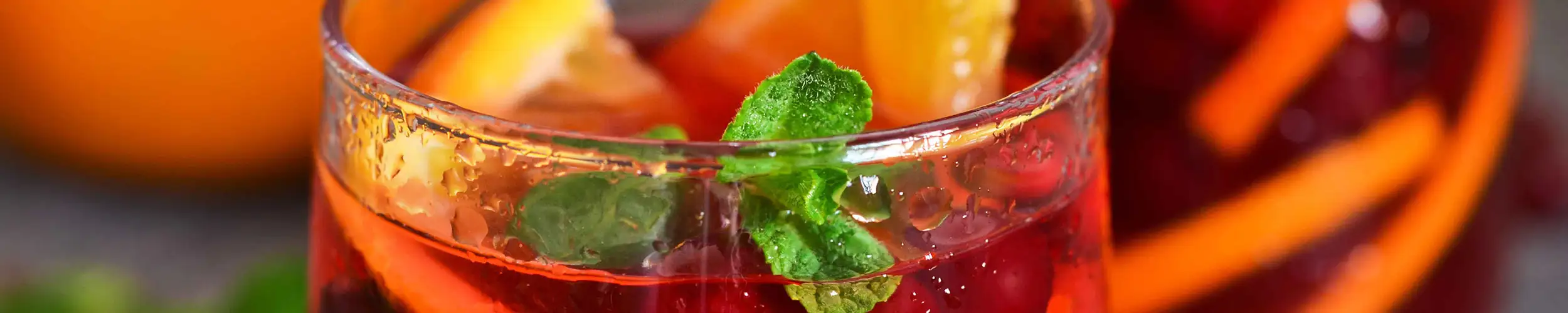 A glass filled with a fruity red cocktail
