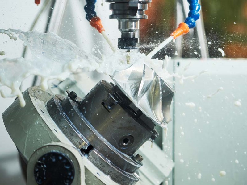 A 5-axis milling machine cuts a complex fan blade
