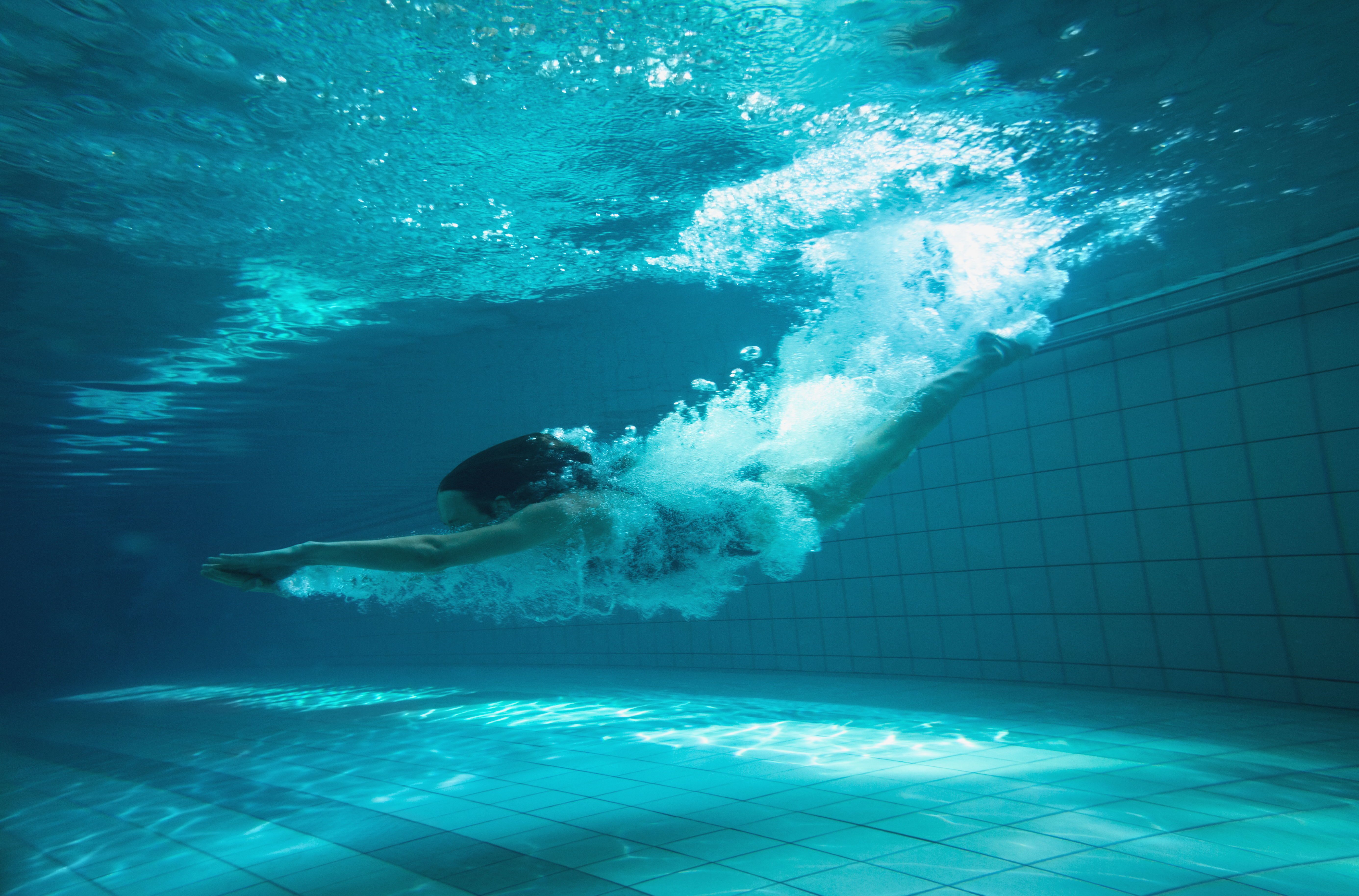 Woman diving into spa swimming pool