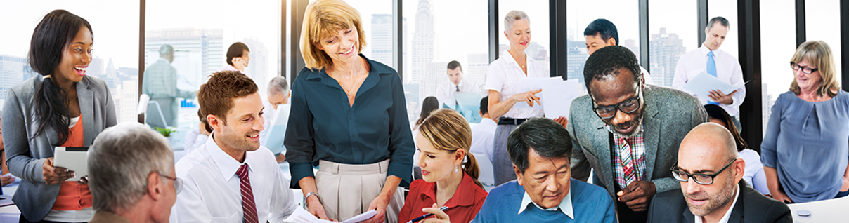 Coworkers talking, looking over one another at a casual meeting.