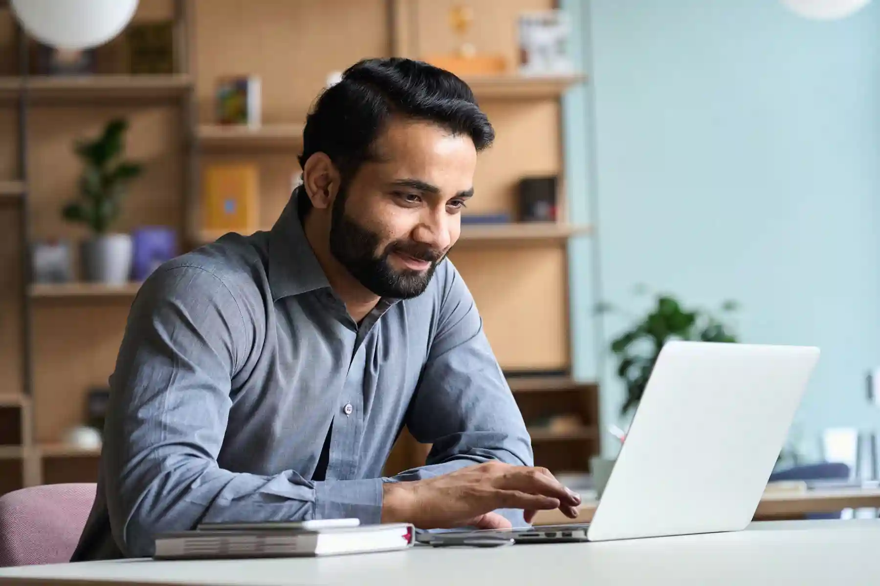 Man smiling and using a computer