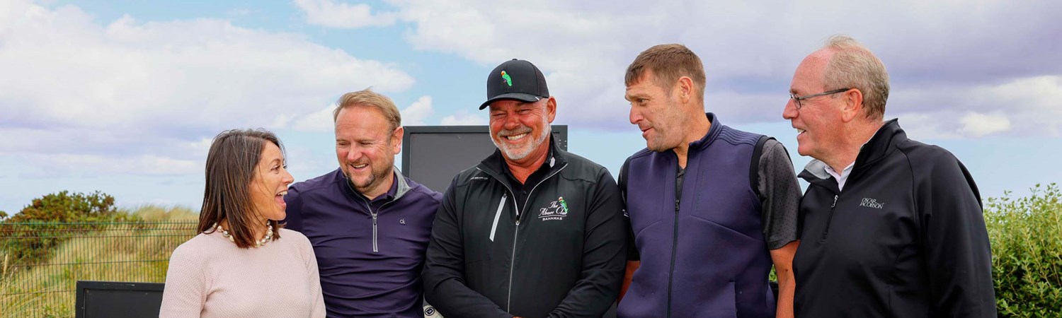 Golfer Darren Clarke posing for a picture with NFP employees.