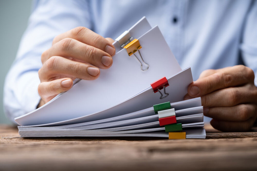 man reading through papers