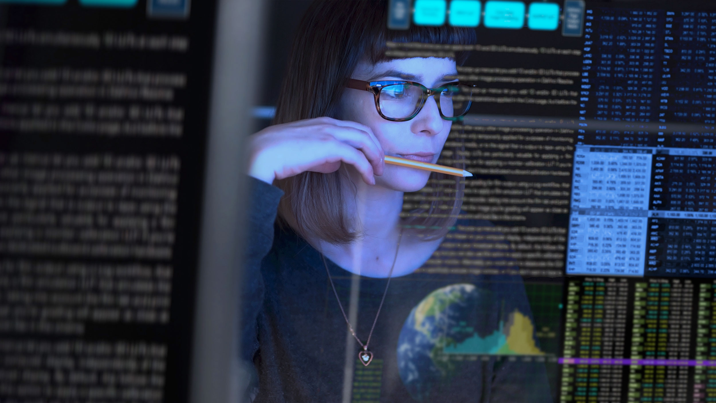A woman analyzes data on a computer screen 